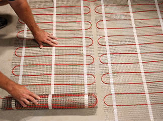 Heat cable pre-spaced in mats being installed.