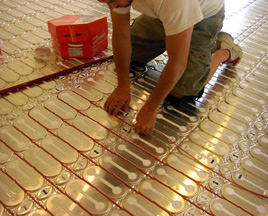 Heat cable being placen in HeatShield floor heating system insulation panels.