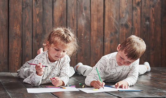 Children on a warm hardwood floor.